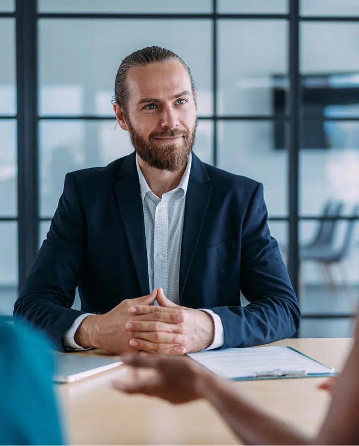 Professional Legal Consultation Professional businessman in a suit attending a client consultation meeting in a modern office