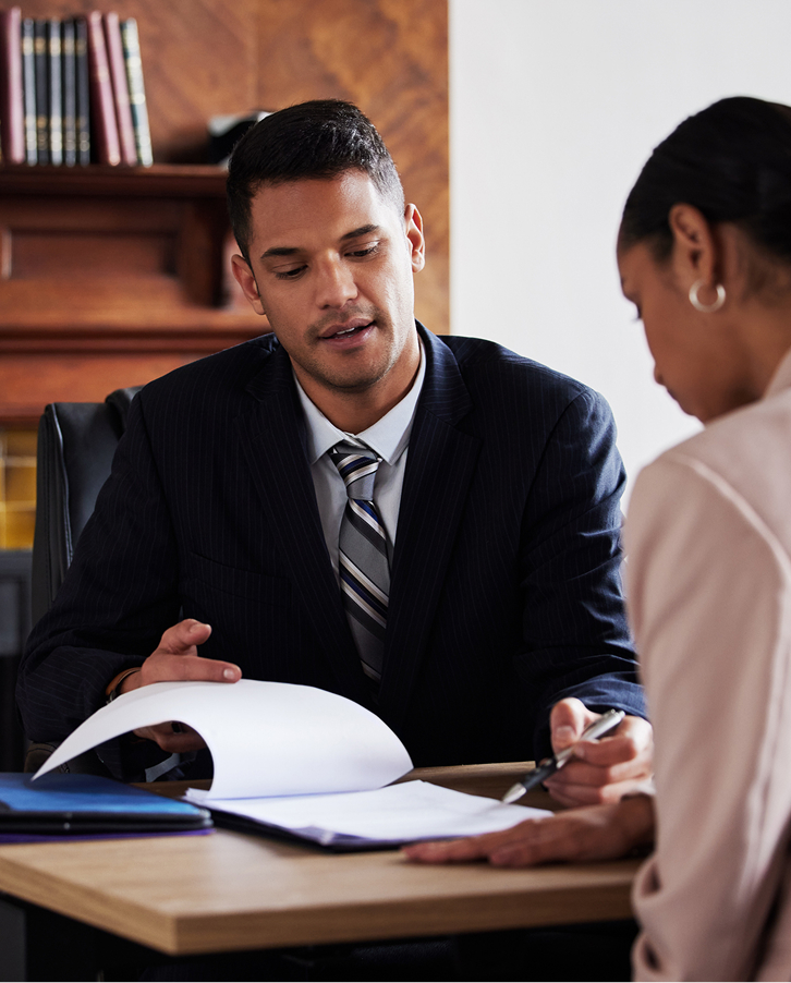 Legal Document Consultation Attorney reviewing legal documents with a client during a professional office consultation